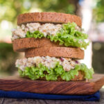 Vegan chicken salad served in a sandwich with lettuce.