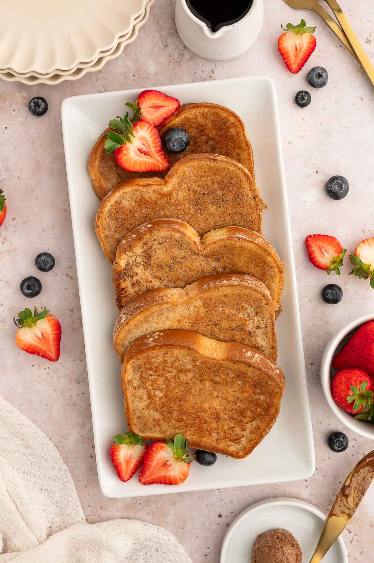 A plate of vegan French toast with fruit.