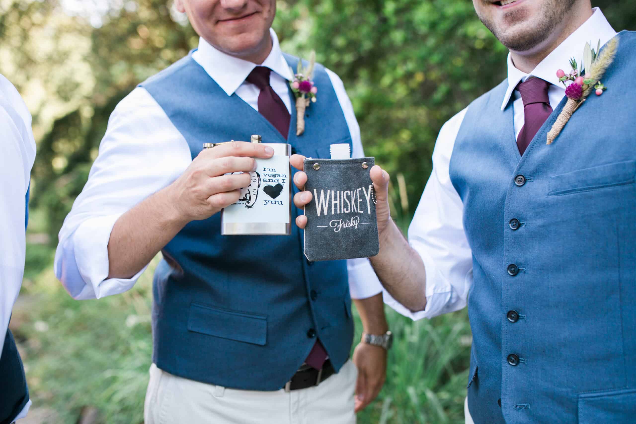 Groom holding a mug that says “Whiskey Business” before the ceremony.