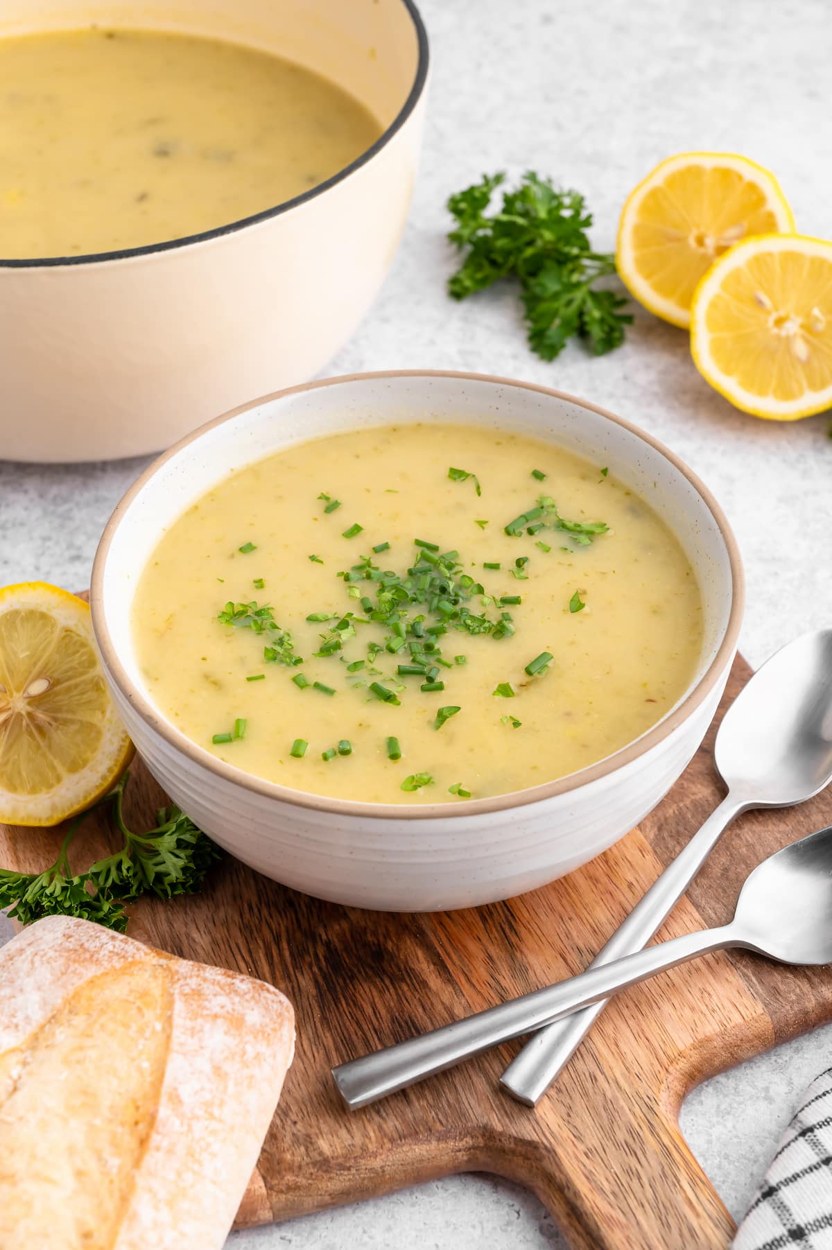 Potato leek soup in a bowl with chopped chives on top.