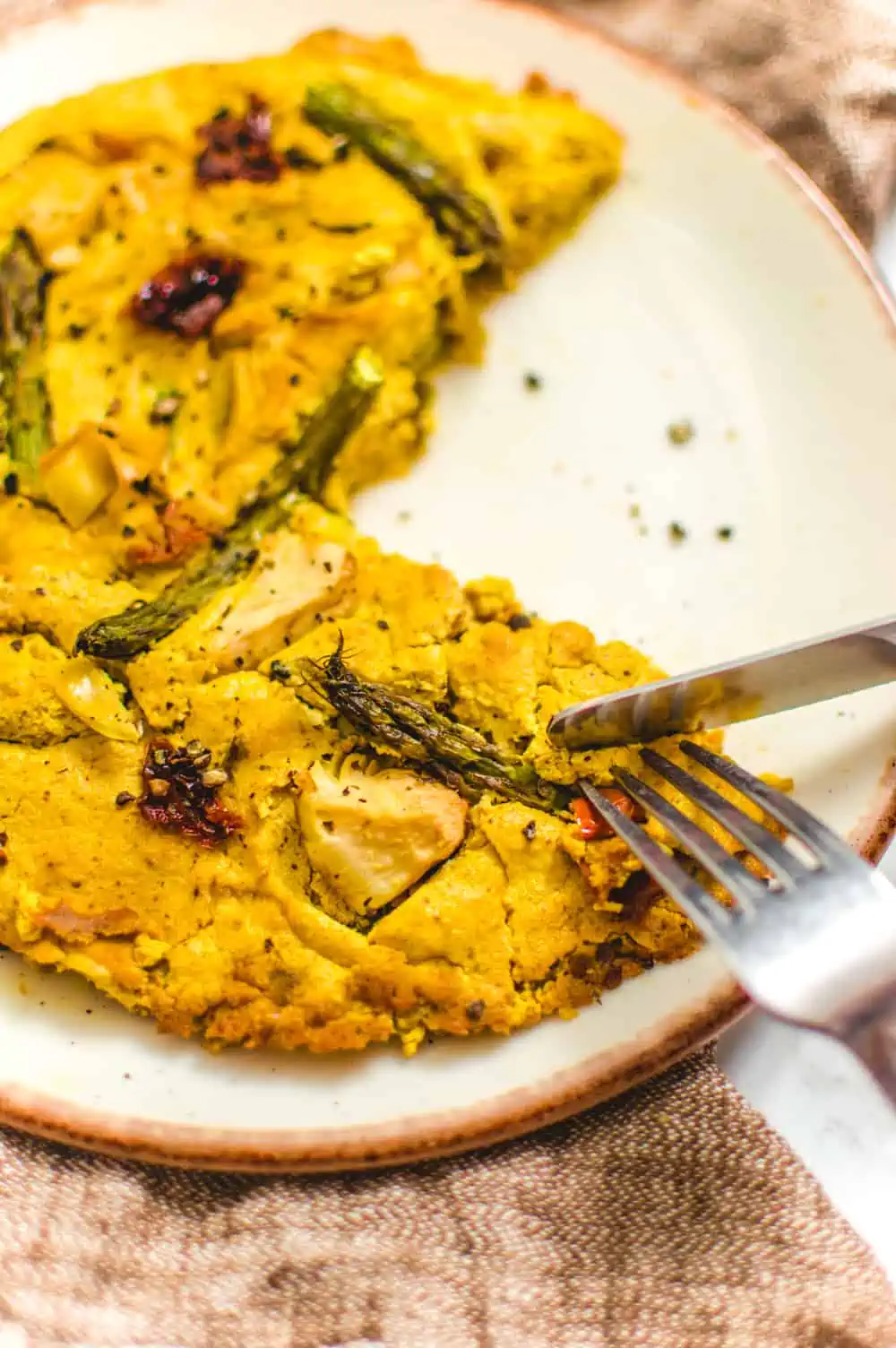 Vegan Frittata Being Cut with a Knife and Fork.