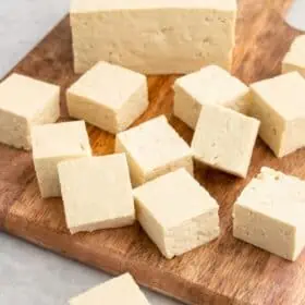 Cubed tofu on a cutting board.