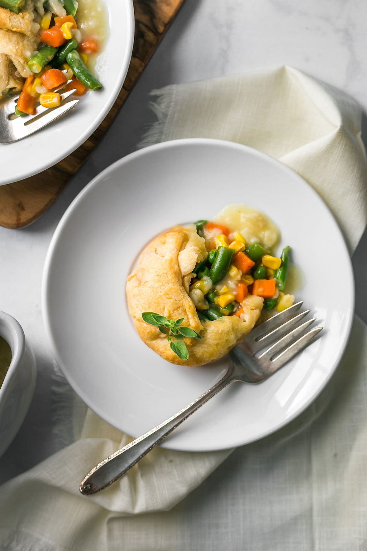 A vegan pot pie on a plate with a fork.