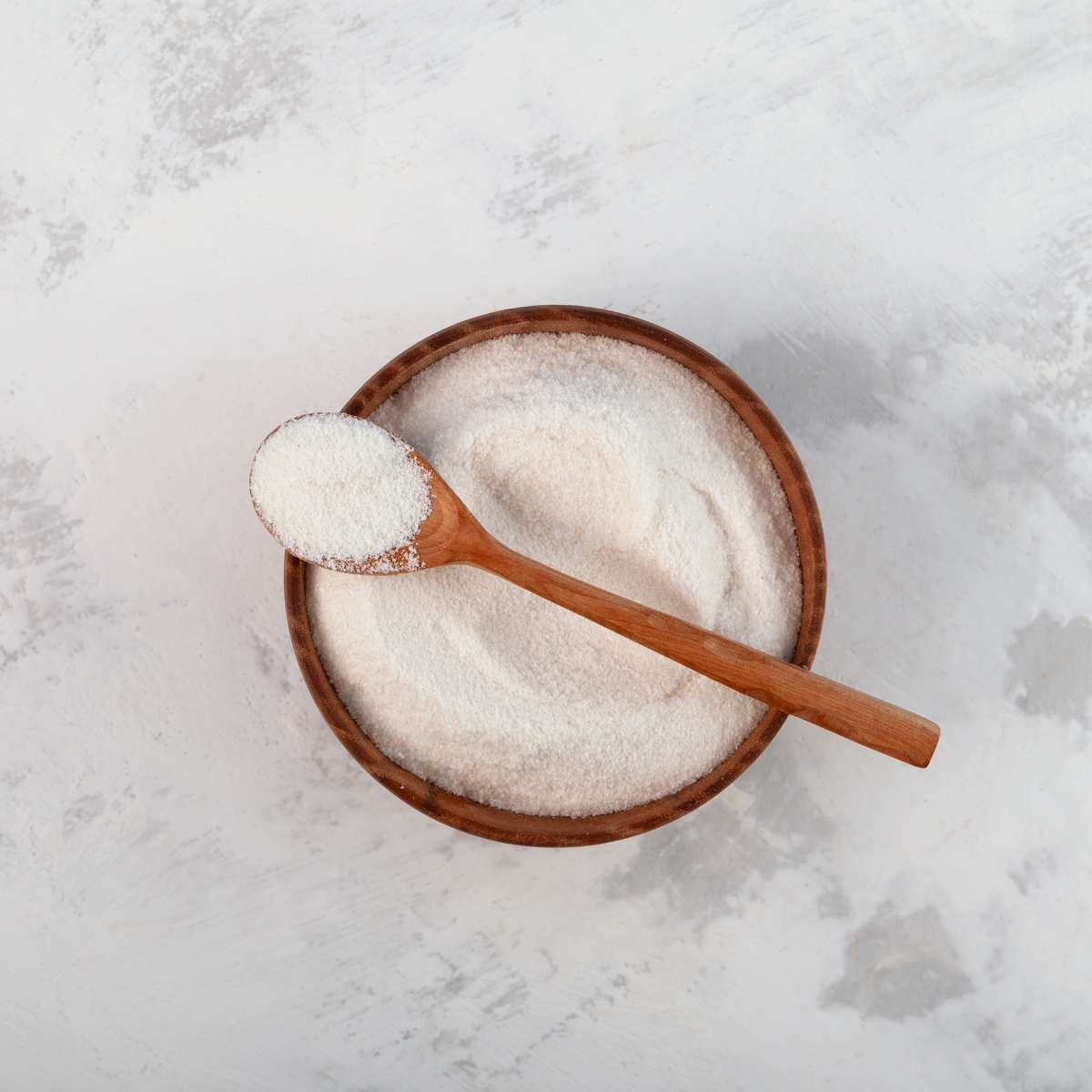 A bowl of carrageenan powder with a spood.