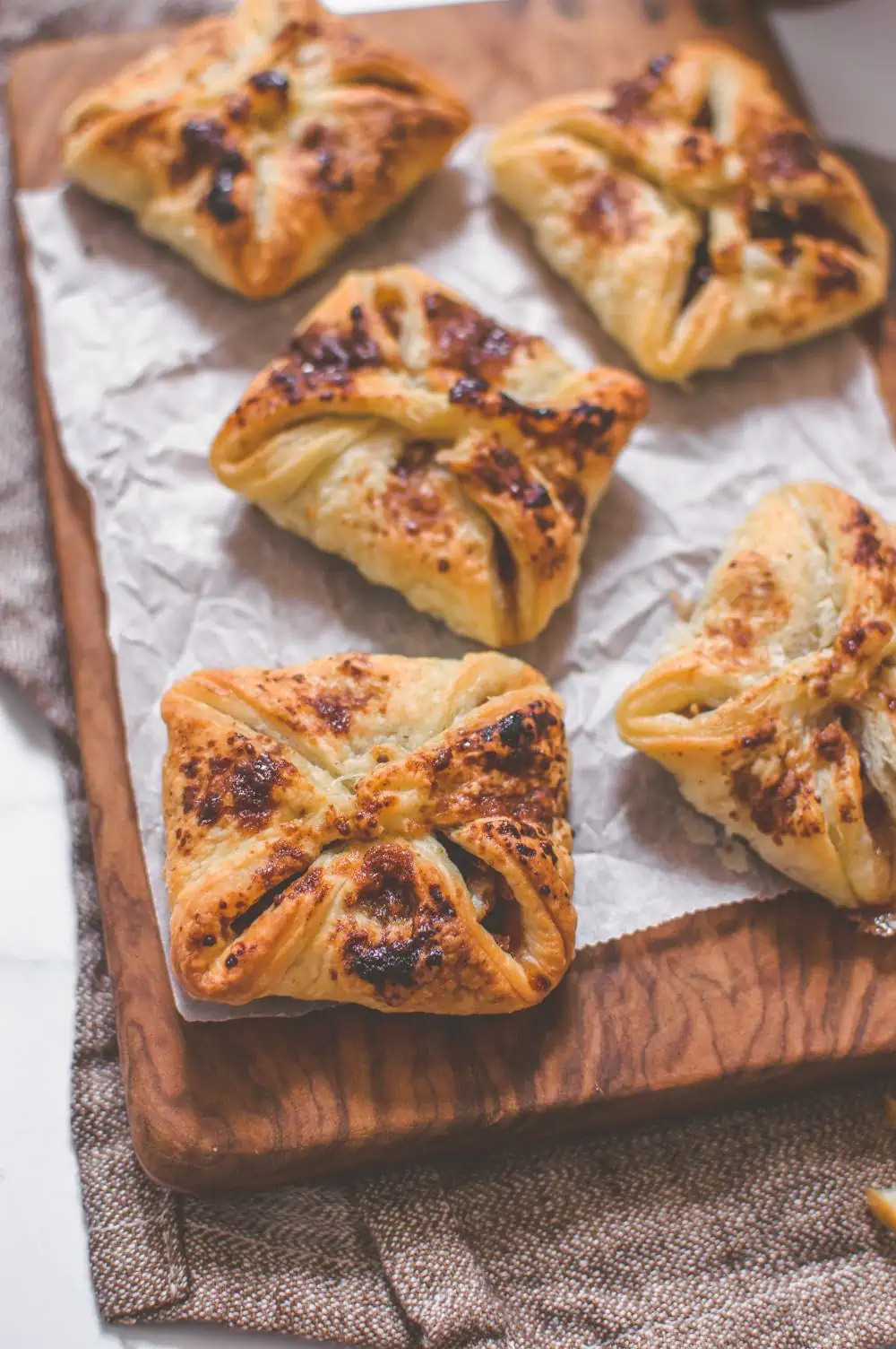 Vegan apple hand pies sitting on a serving board.