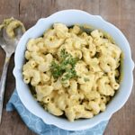 Vegan mac and cheese without cashews, in a serving bowl, topped with chopped parsley.