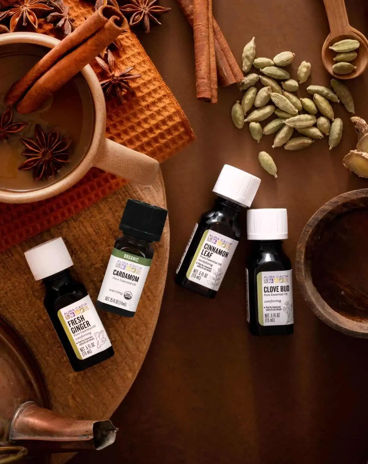 An arrangement of essential oils against a warm, wooden background.