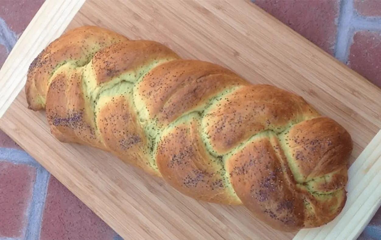 Vegan challah bread loaf on a cutting board. 