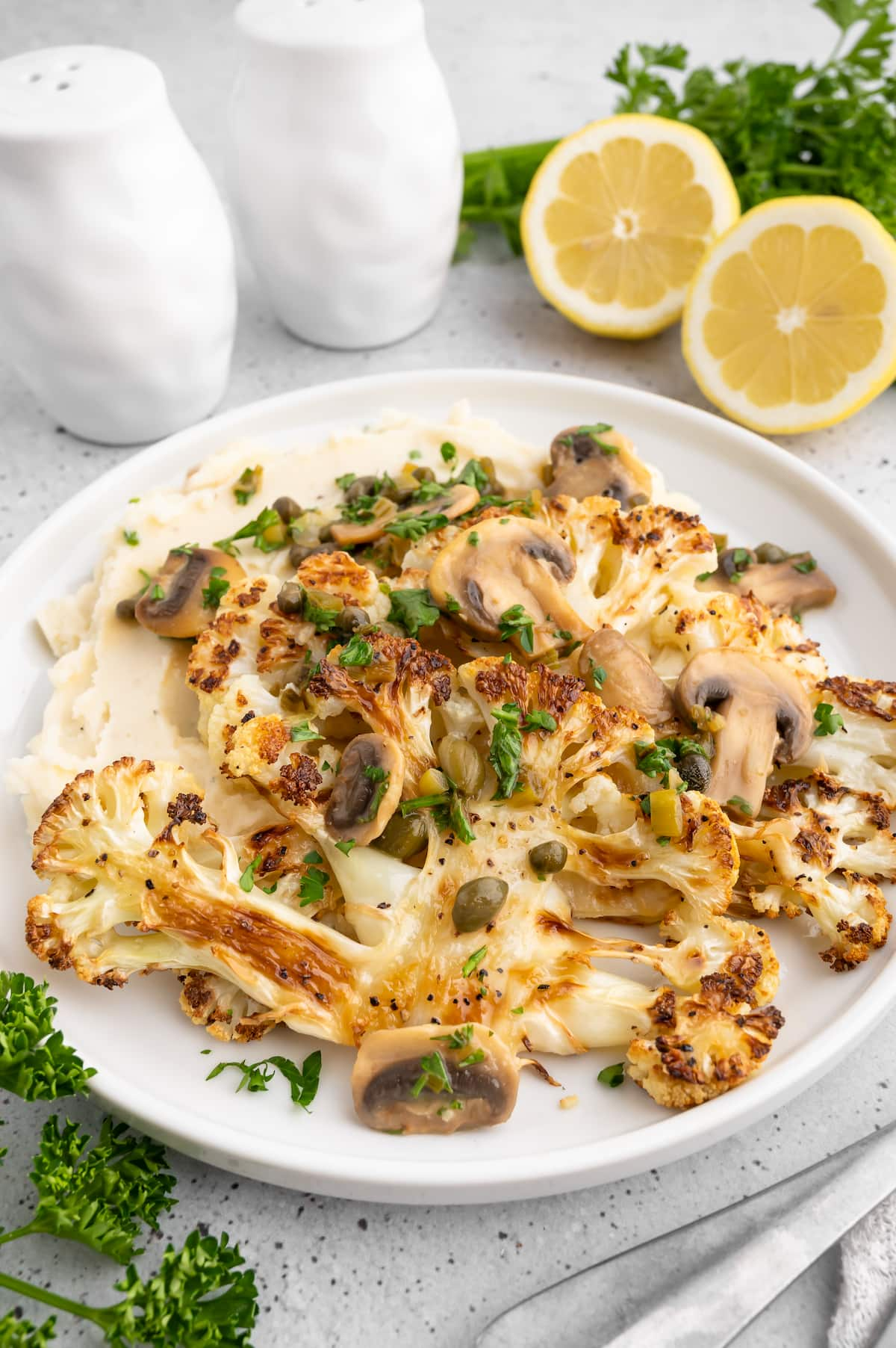 Cauliflower steaks layered on a plate.