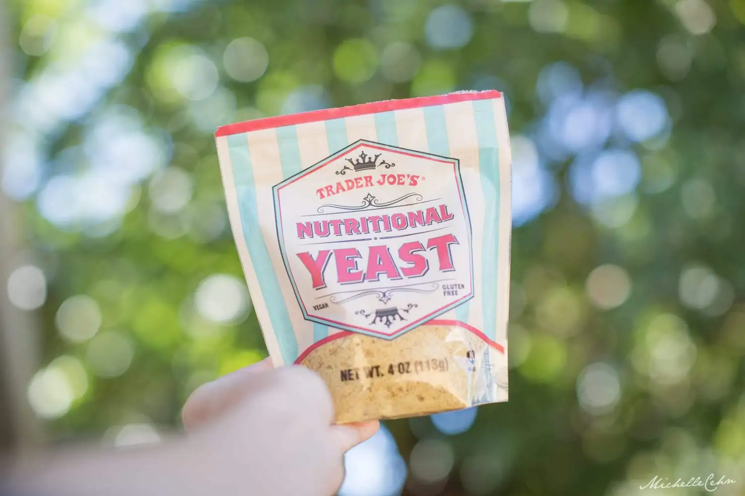 Hand holding up a bag of Trader Joe's Nutritional Yeast.