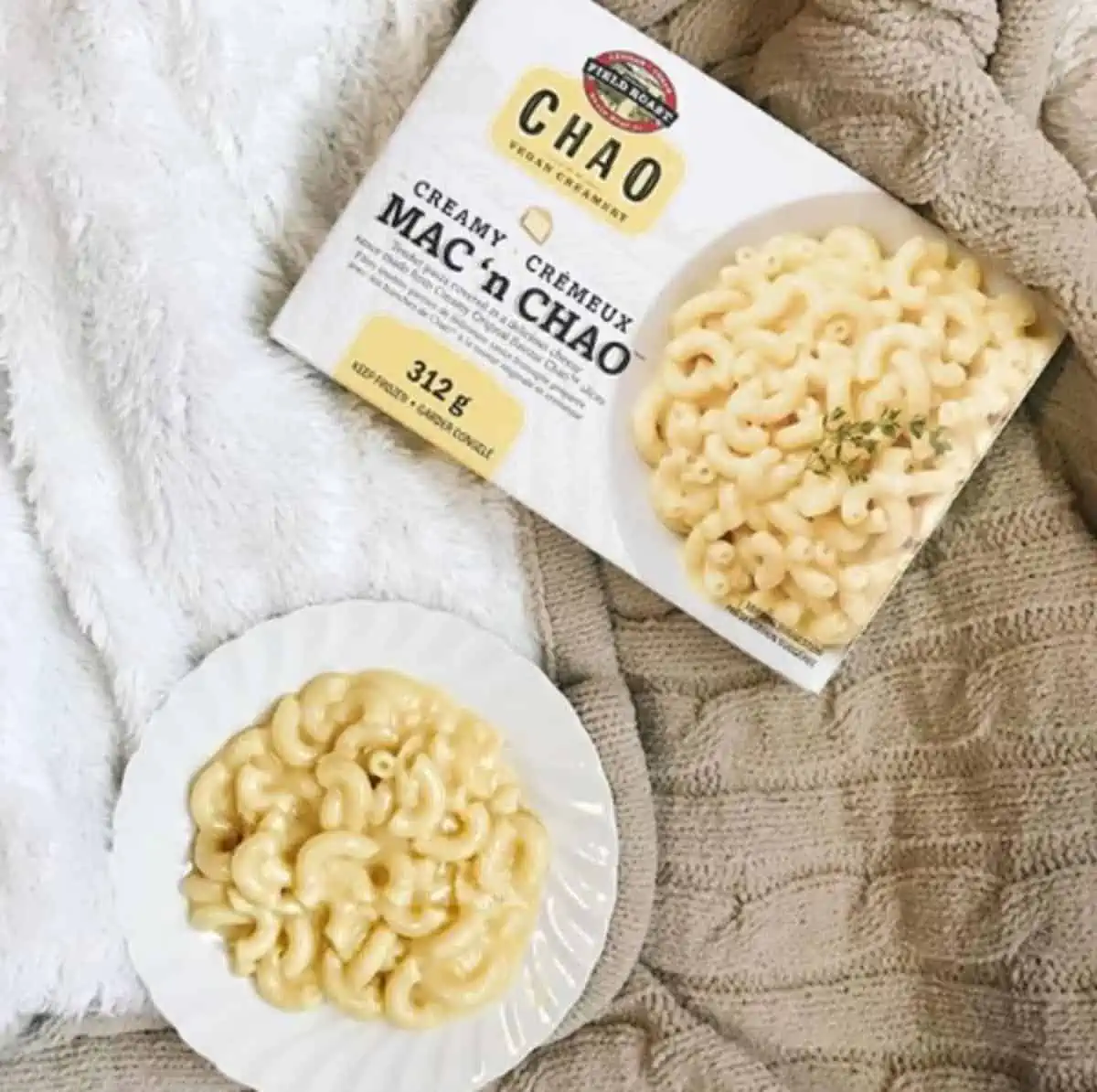 A bowl of dairy free mac and cheese next to a box of Field Roast Mac & Chao.
