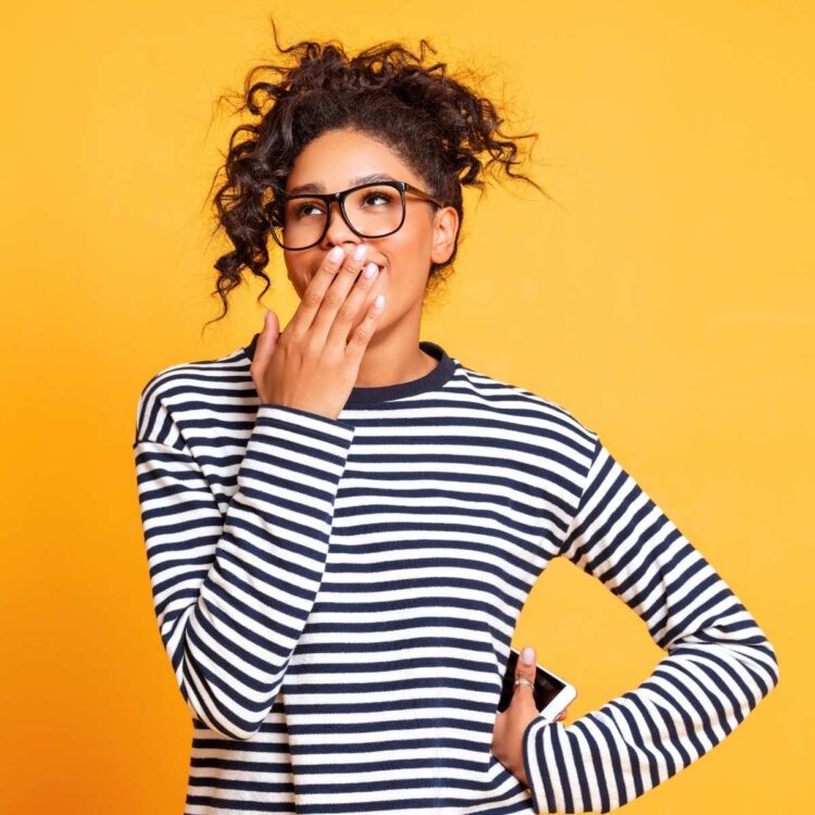A woman covering her mouth.