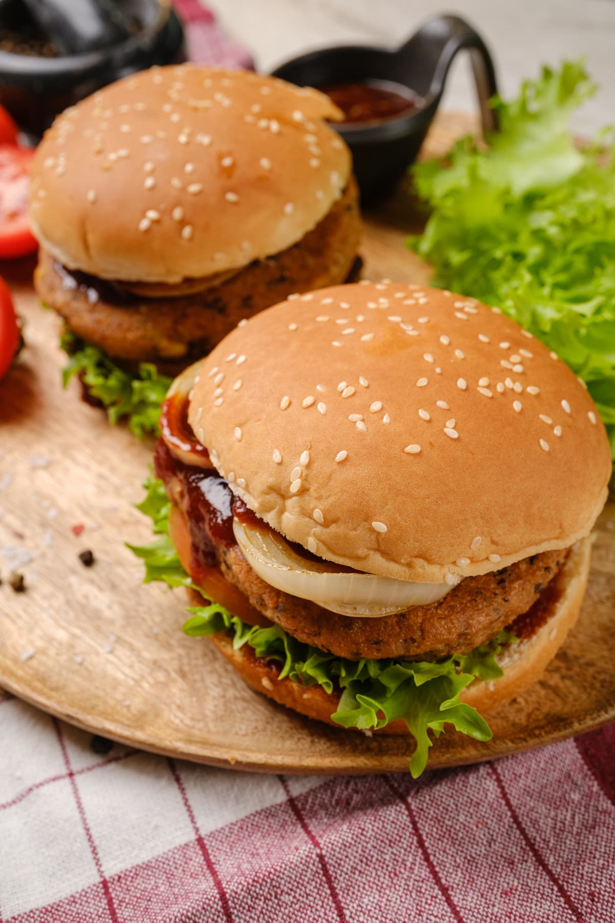 Two chipotle bean burgers served in buns with toppings.