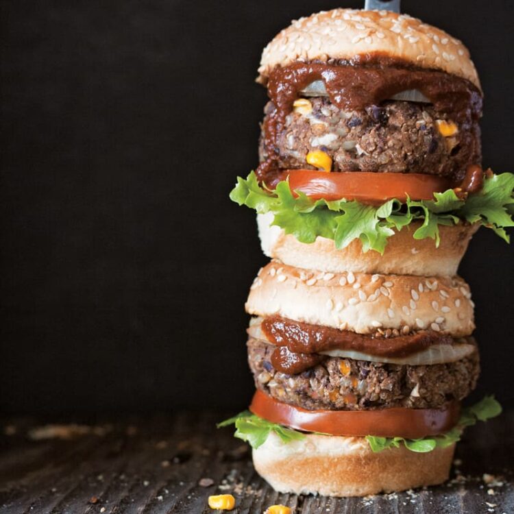 Two vegan black bean burgers stacked.