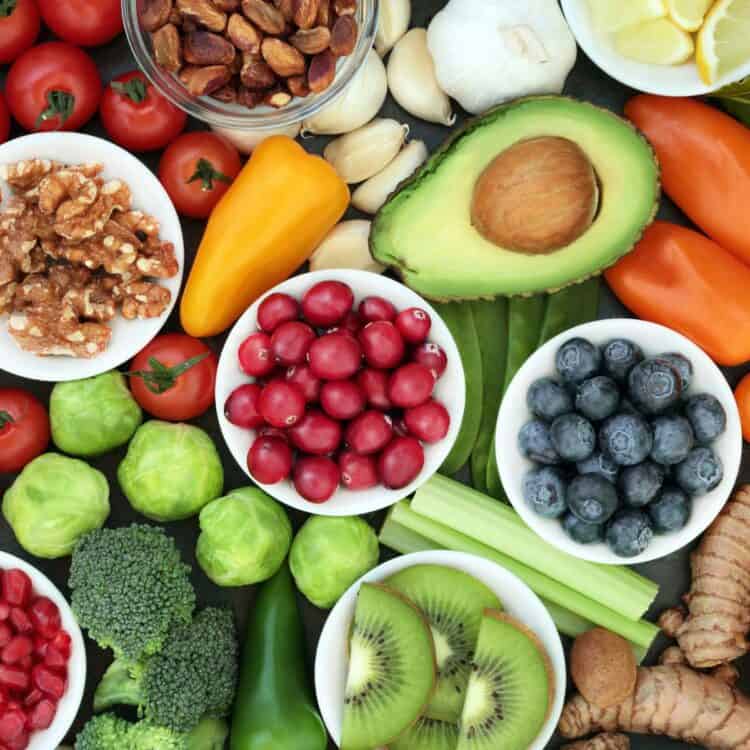 A variety of fruits and vegetables in bowls.