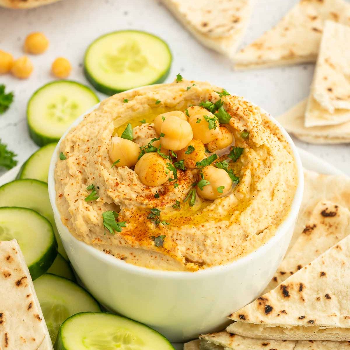 A bowl of oil-free hummus garnished with chickpeas.