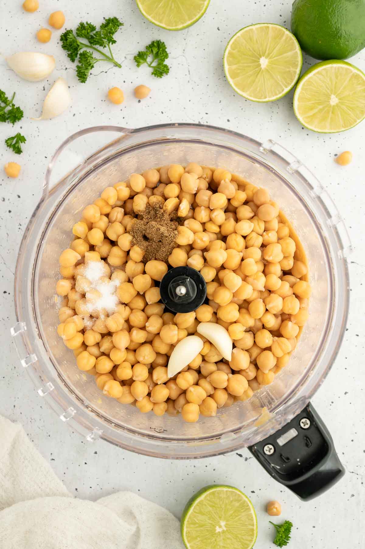 Chickpeas, spices, salt, and garlic in a food processor.