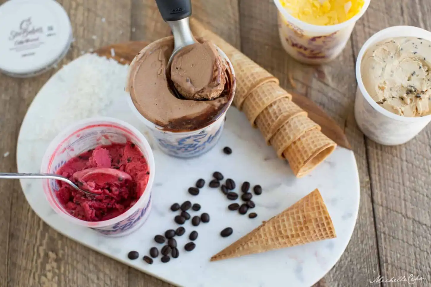 Pints of dairy-free ice cream with waffle cones.