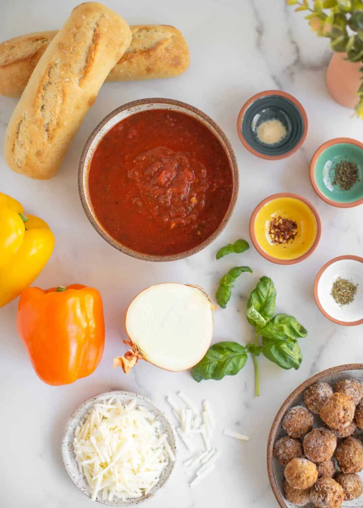 Ingredients for this vegan meatball sub sandwich laid out on a table. 