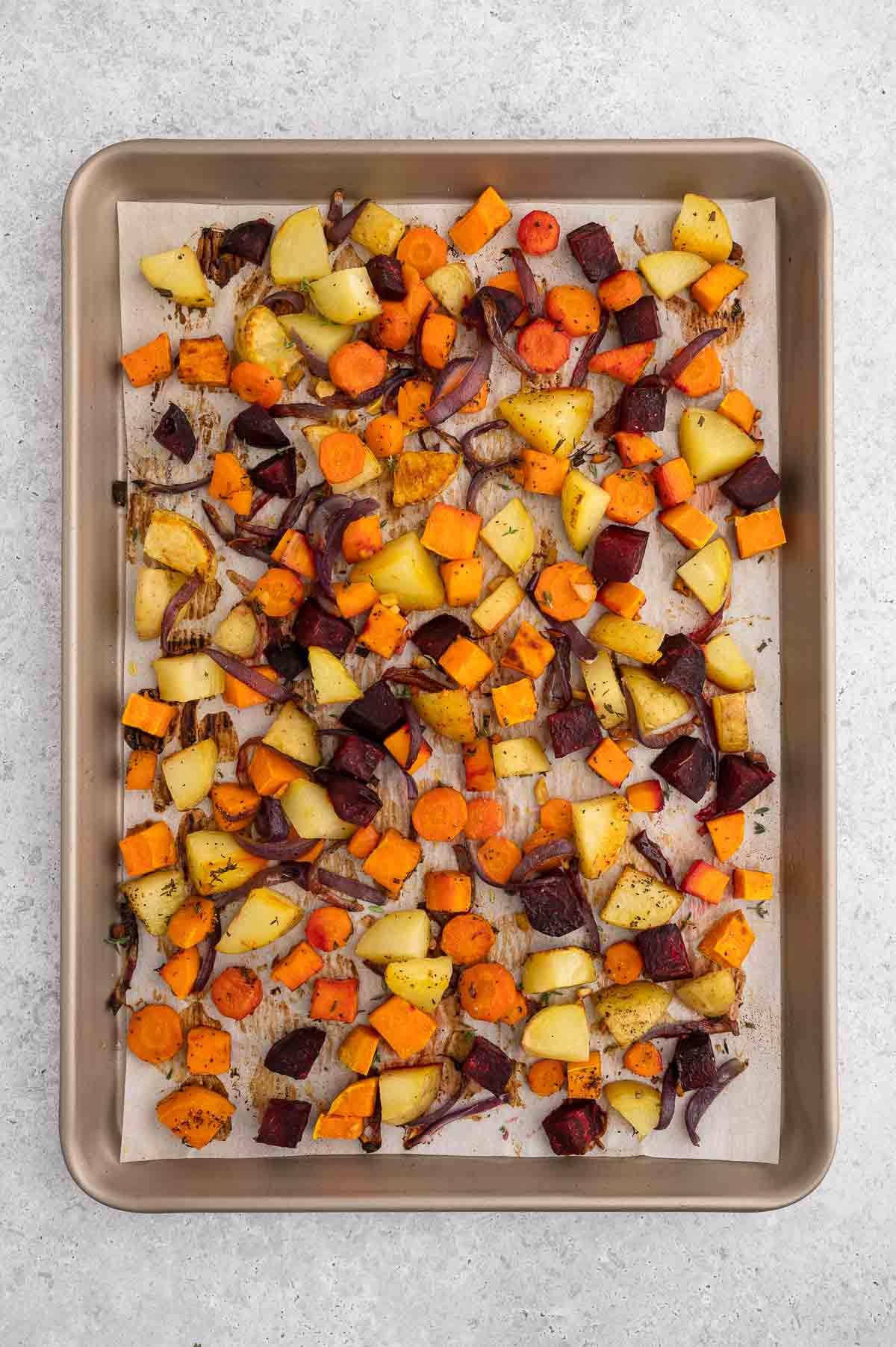 Roasted root vegetables on a baking sheet.