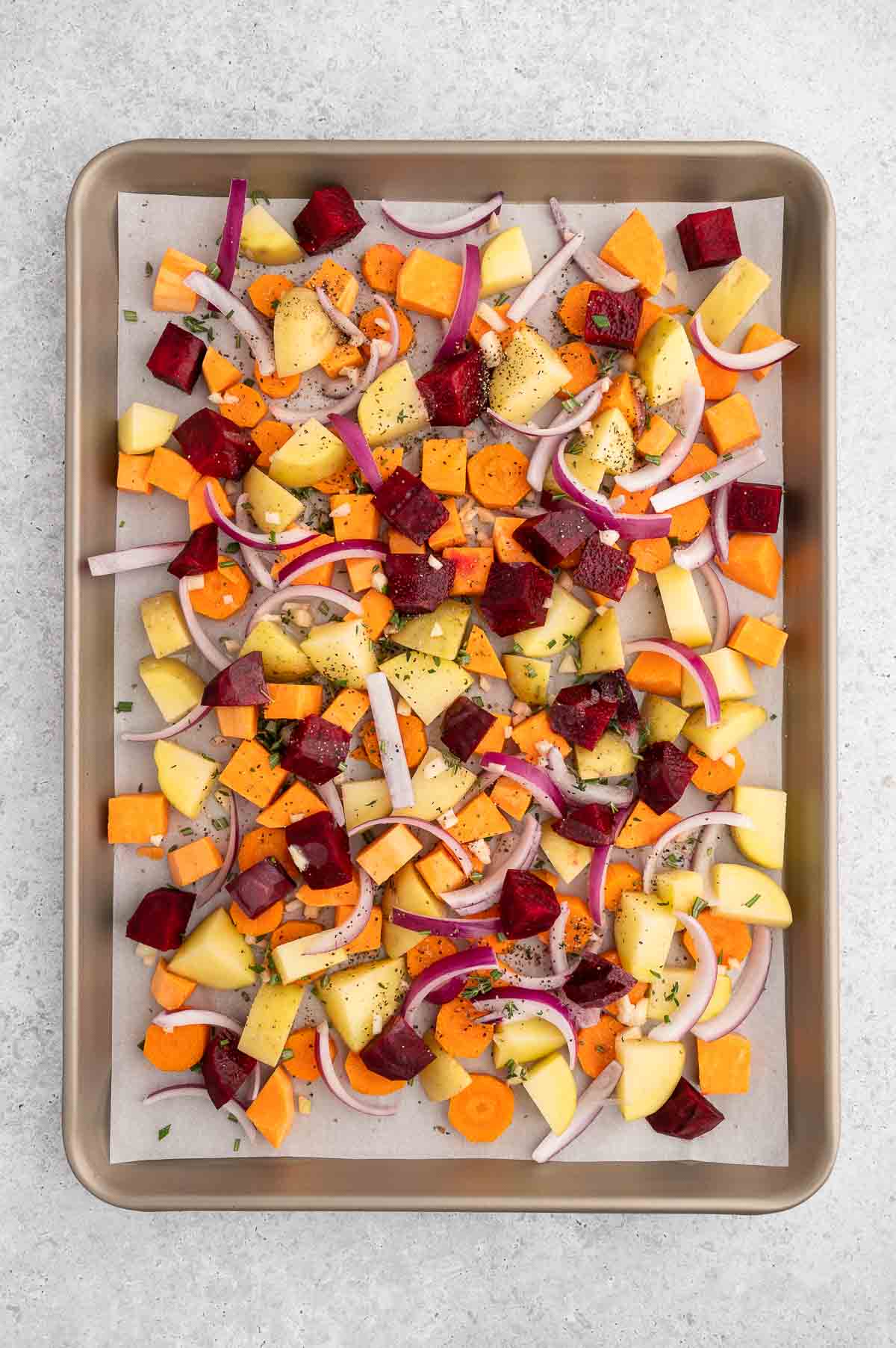 Chopped root vegetables on a baking sheet.