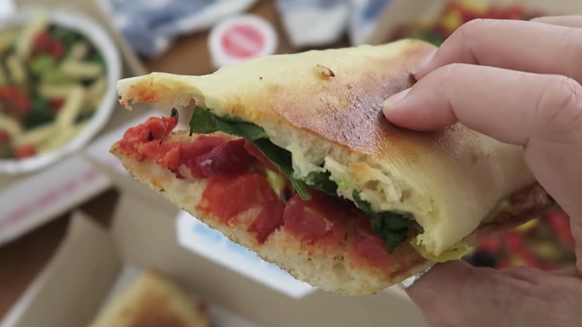 Dominos Vegan Mediterranean Veggie Sandwich Held in a Womans Hand