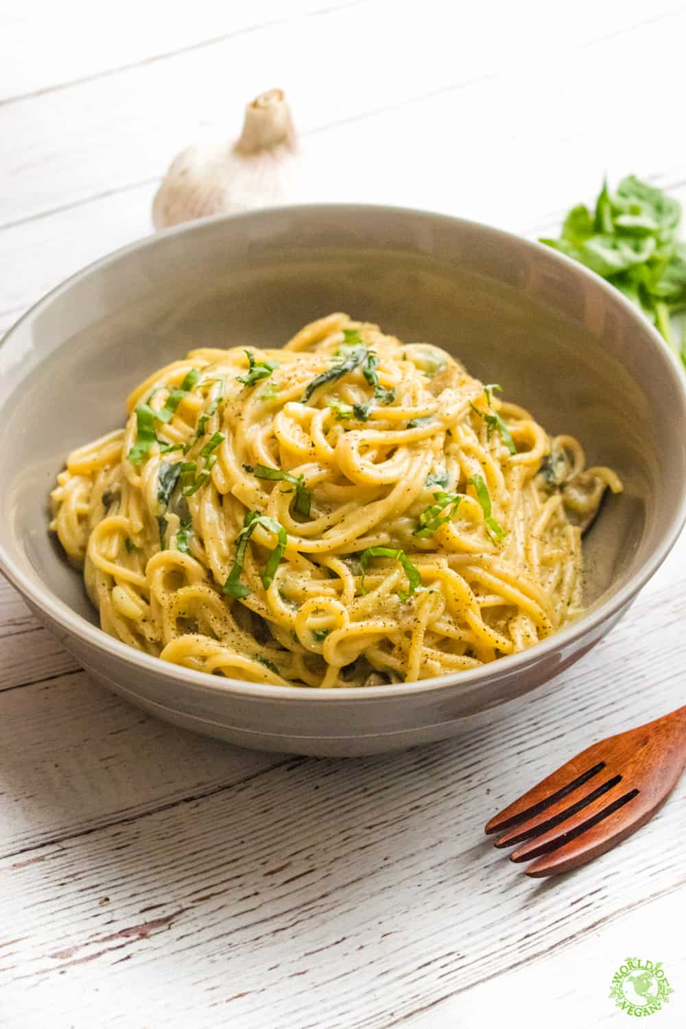 vegetarian one pot pasta easy weeknight dinner on a  table with a wooden fork and garlic