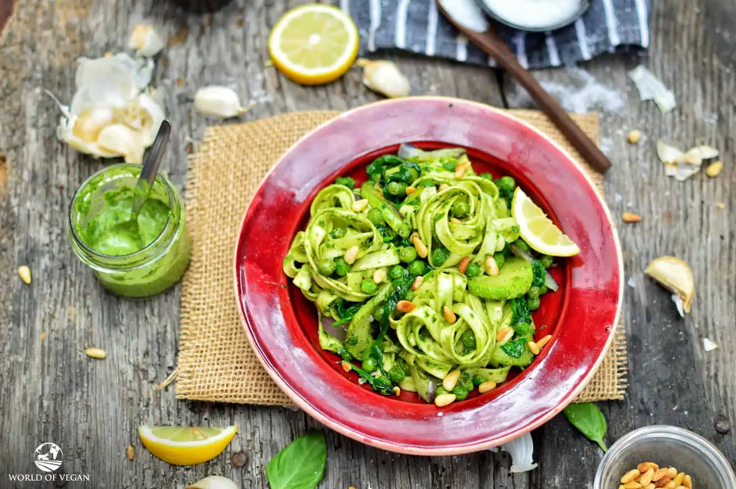 Vegan pesto sauce mixed into linguine pasta with vegetables on a plate.