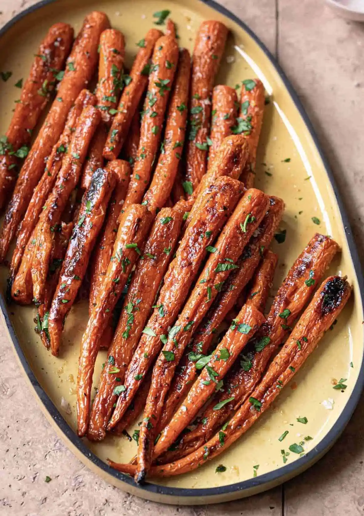 Elegant serving platted with long roasted carrots. 