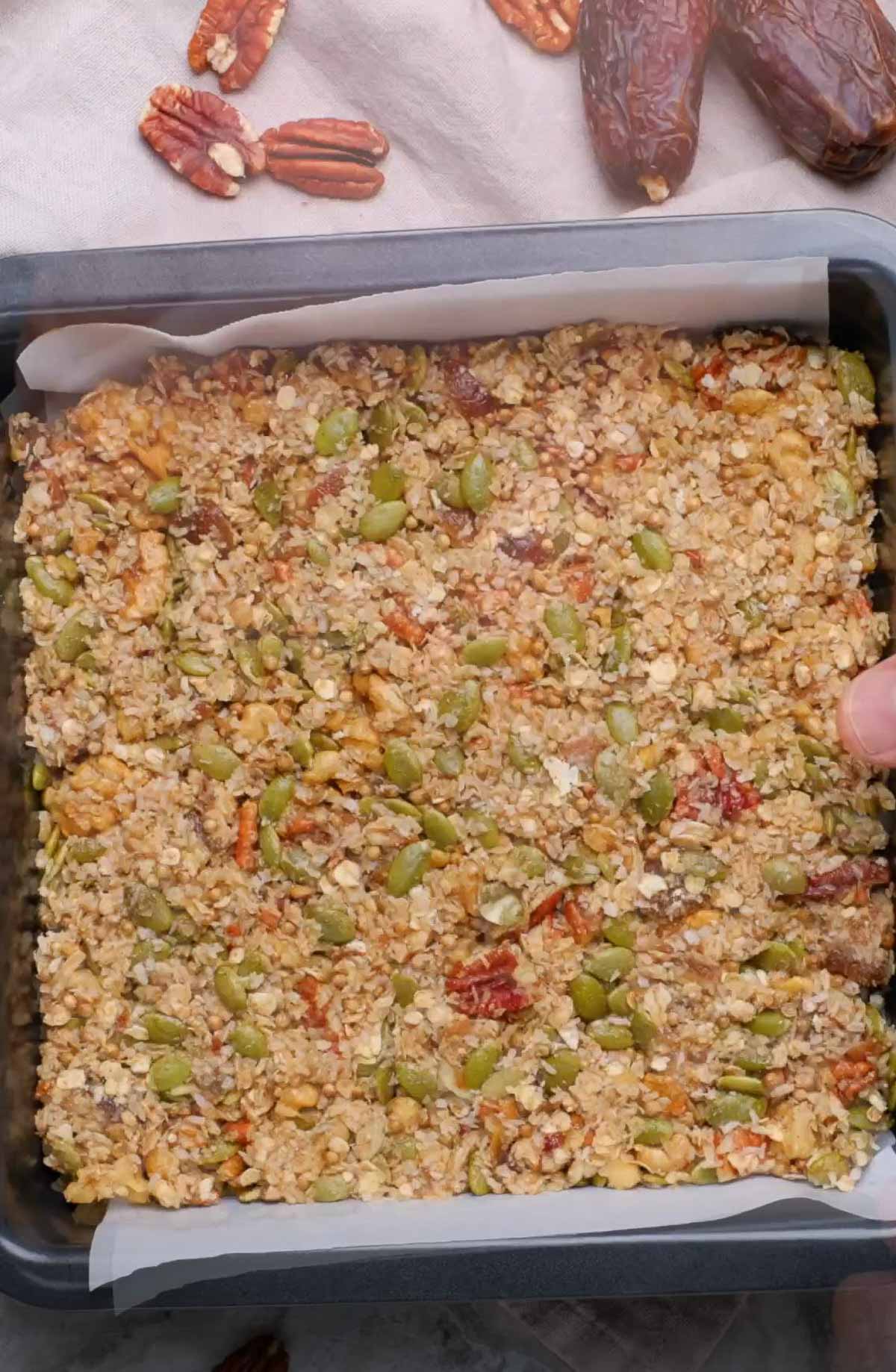 Vegan granola bars pressed in a baking tray.