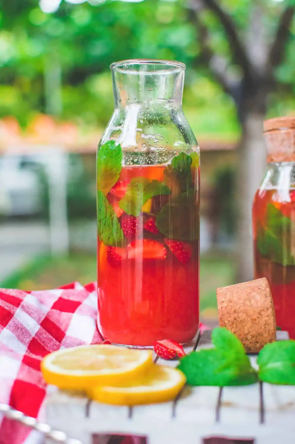 A carafe of strawberry mint lemonade, a refreshing complement to vegan picnic ideas.