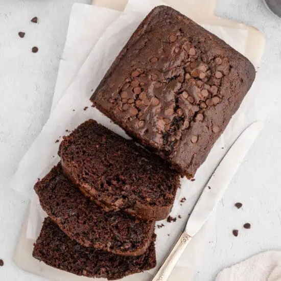 A sliced loaf of vegan chocolate zucchini bread.