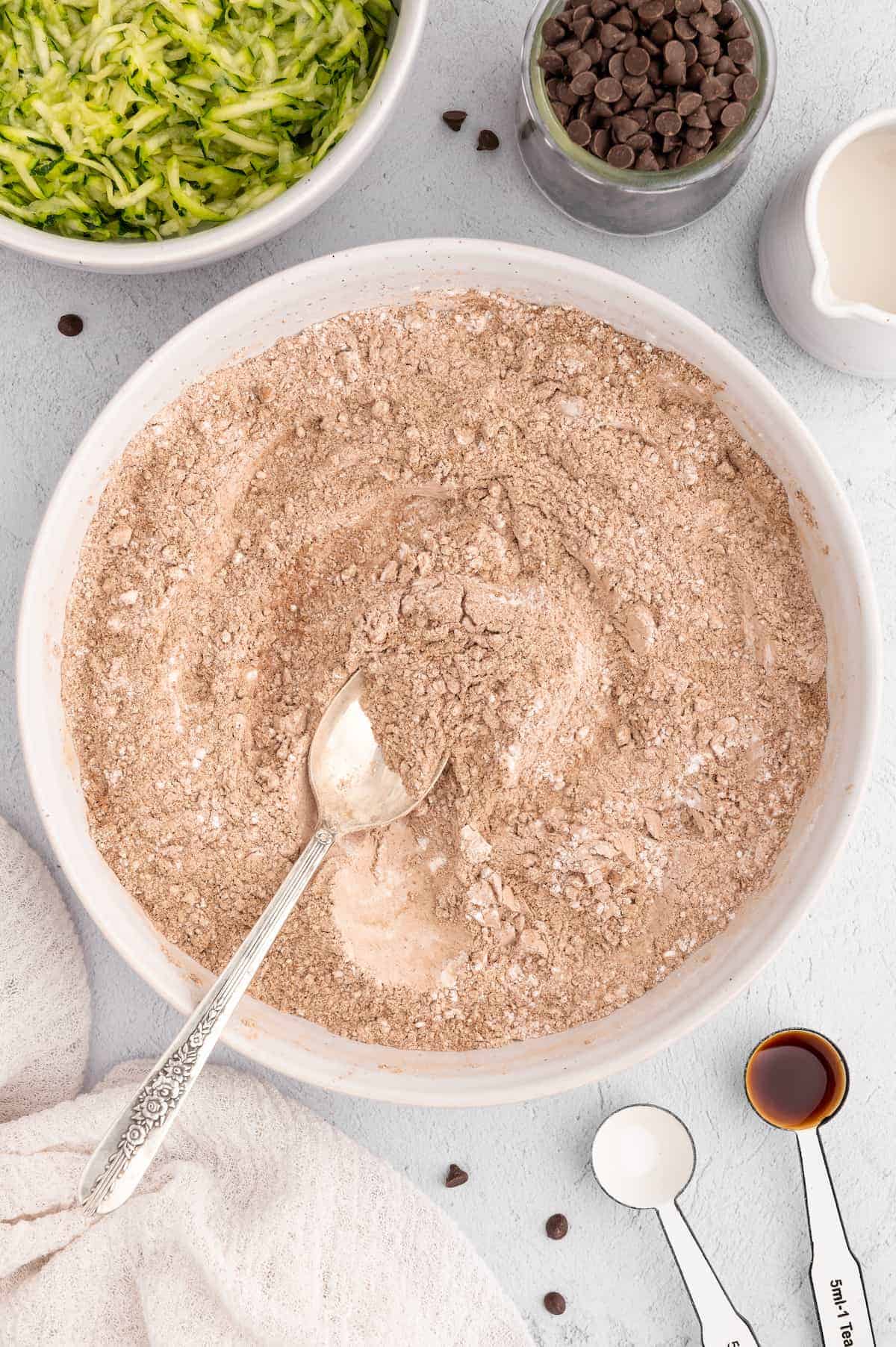 Dry ingredients for making a vegan chocolate zucchini bread in a bowl.