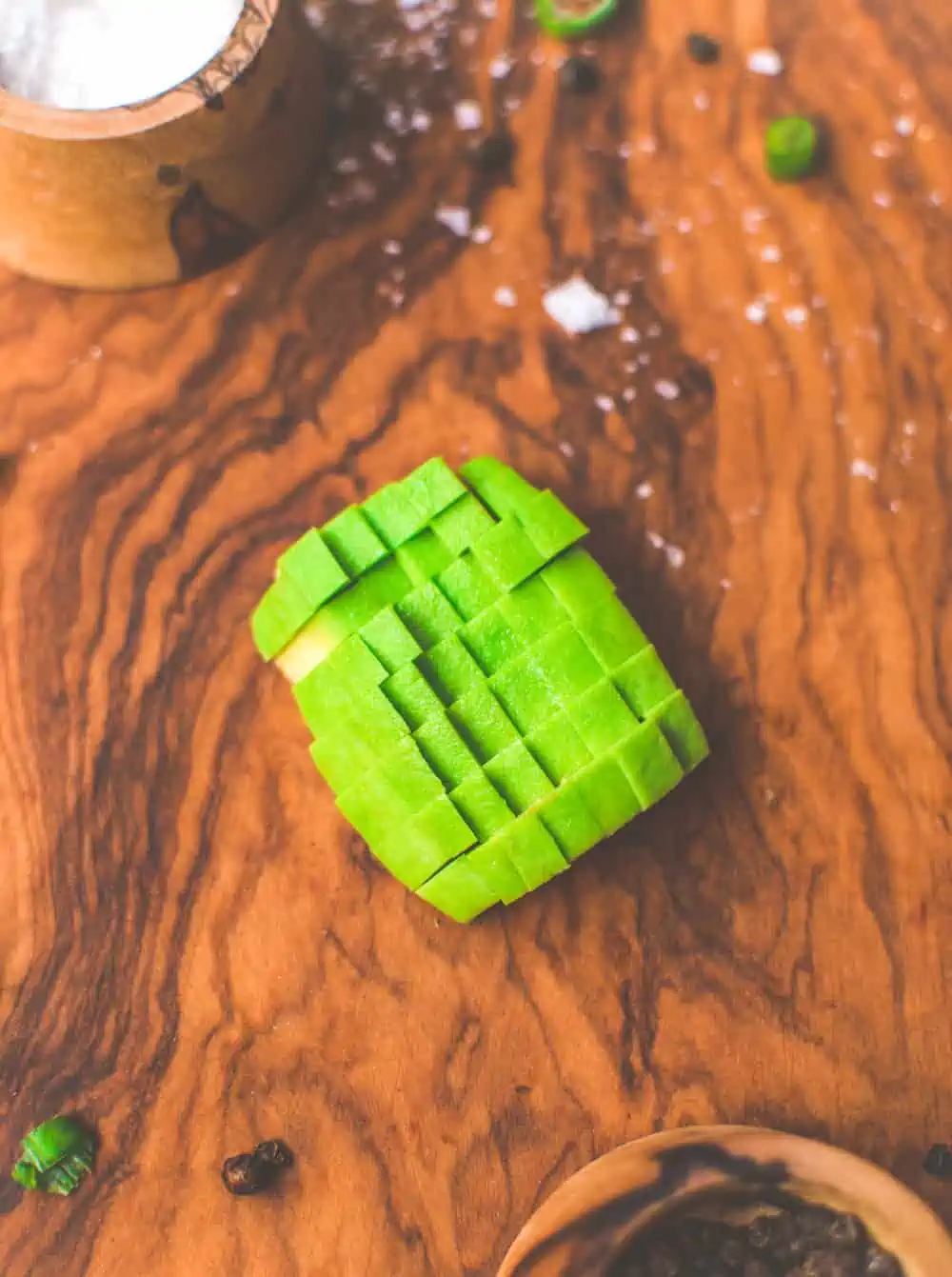 Avocado diced on a cutting board.