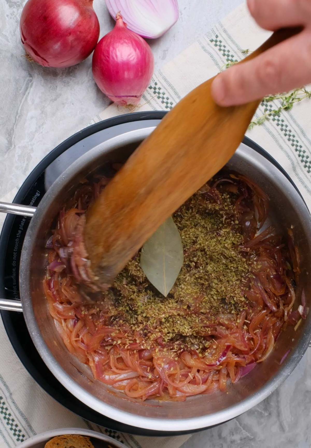 Vegan French Onion Soup being prepared in a pot.