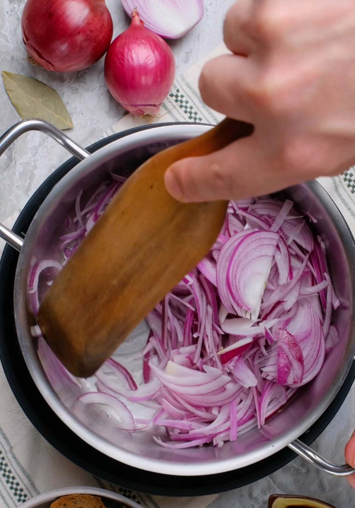 Sliced red onions in a pot.