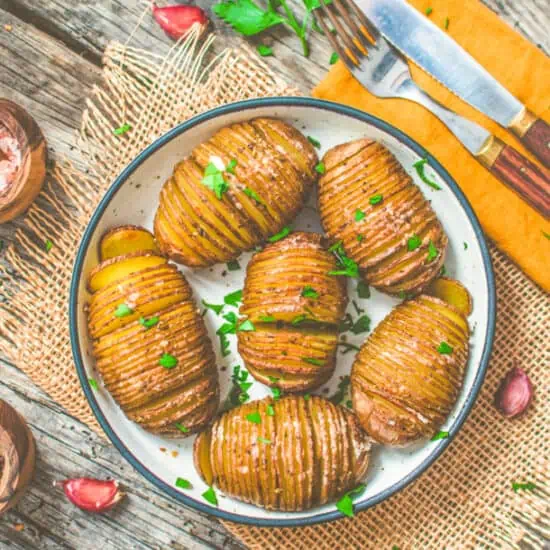 Vegan Hasselback Potatoes served on a table