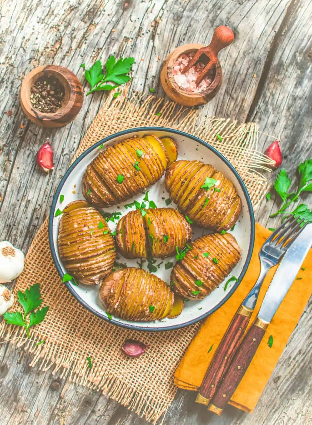 World of Vegan Hasselback Potatoes sprinkled with parsley 