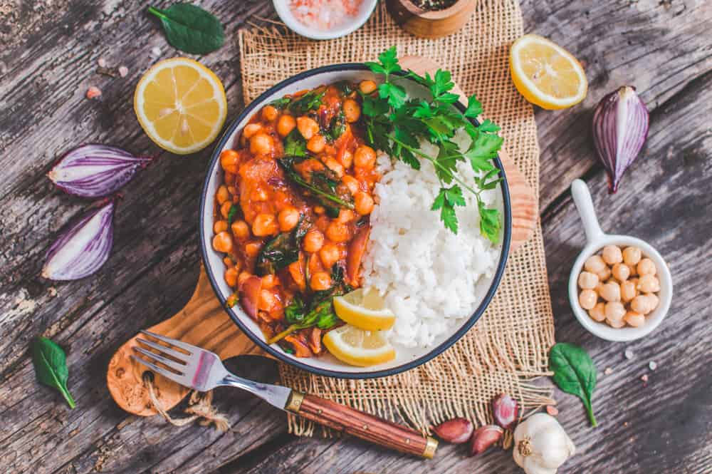 Vegan chickpea Stew Served on a Dish with Ingredients around