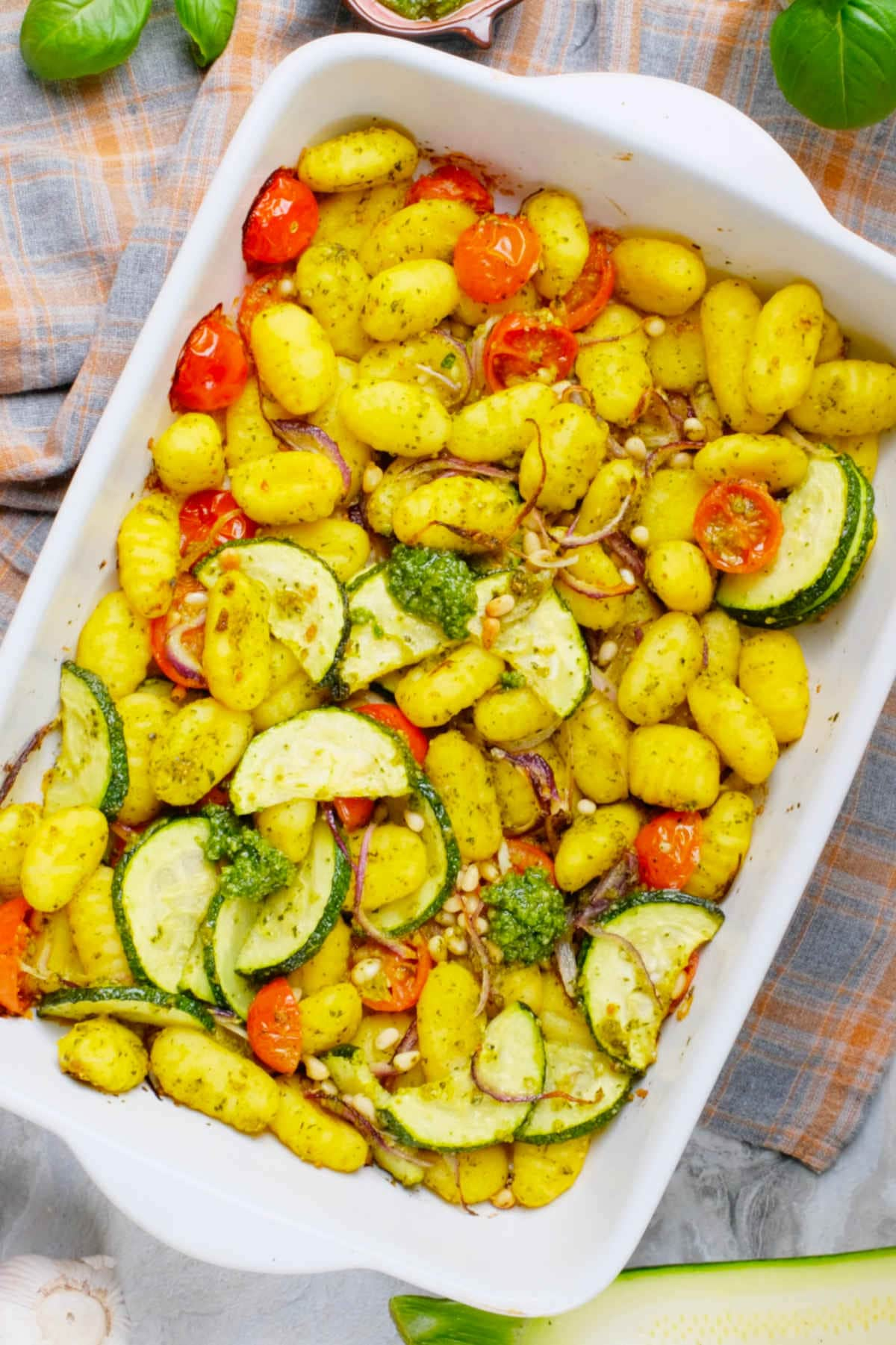 Pesto gnocchi in a casserole dish.