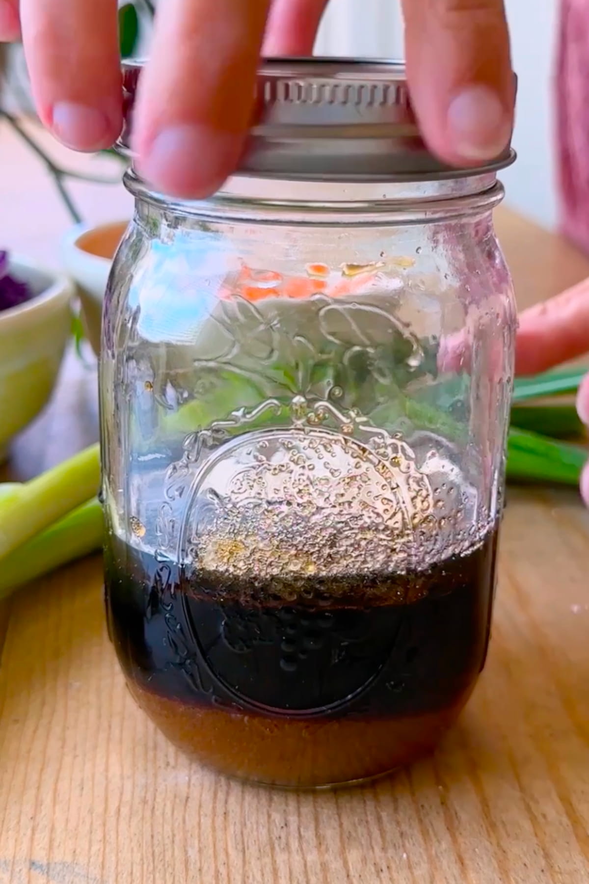 Dressing ingredients added to a glass jar.