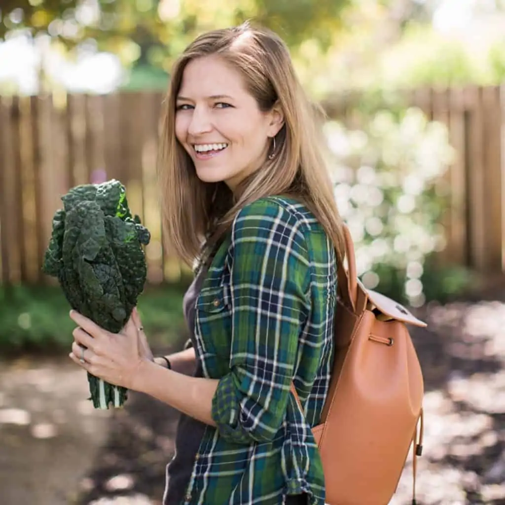 Michelle Cehn holding bunch of fresh lacinato dino kale