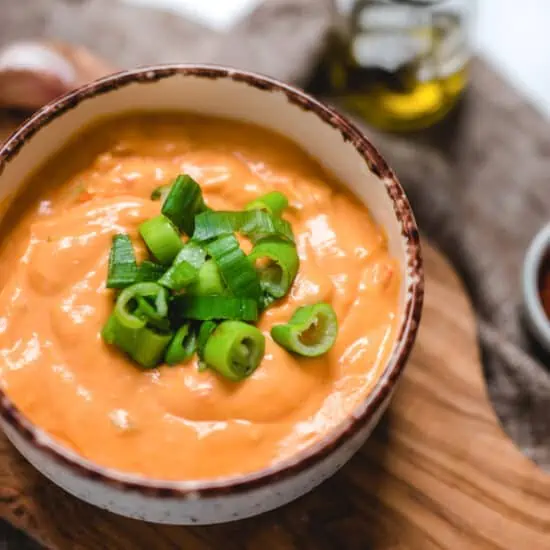 Bowl of Buffalo Mac and Cheese Sauce Close up with Green Onions on Top.