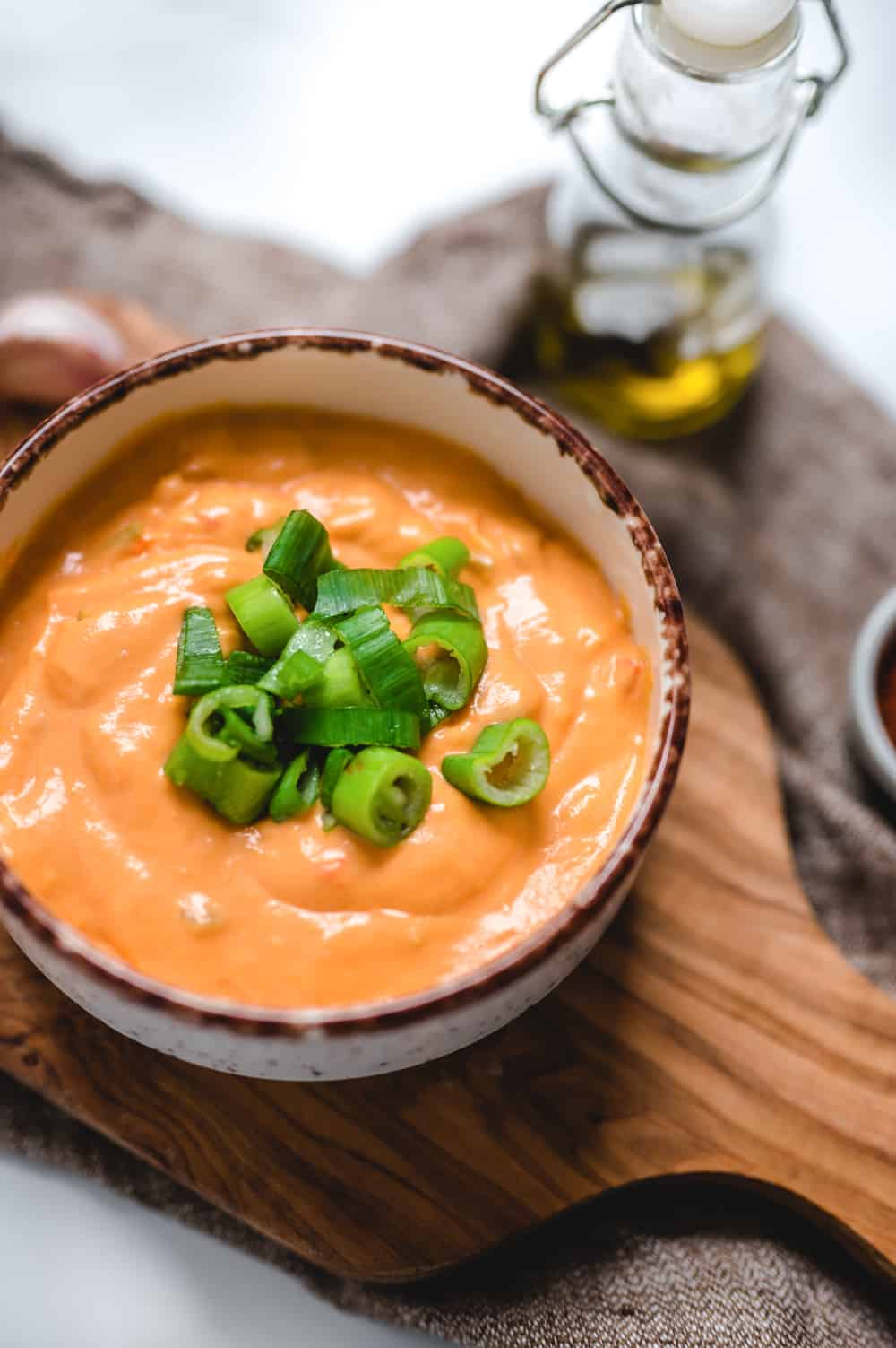 Bowl of Buffalo Mac and Cheese Sauce Close up with Green Onions on Top.