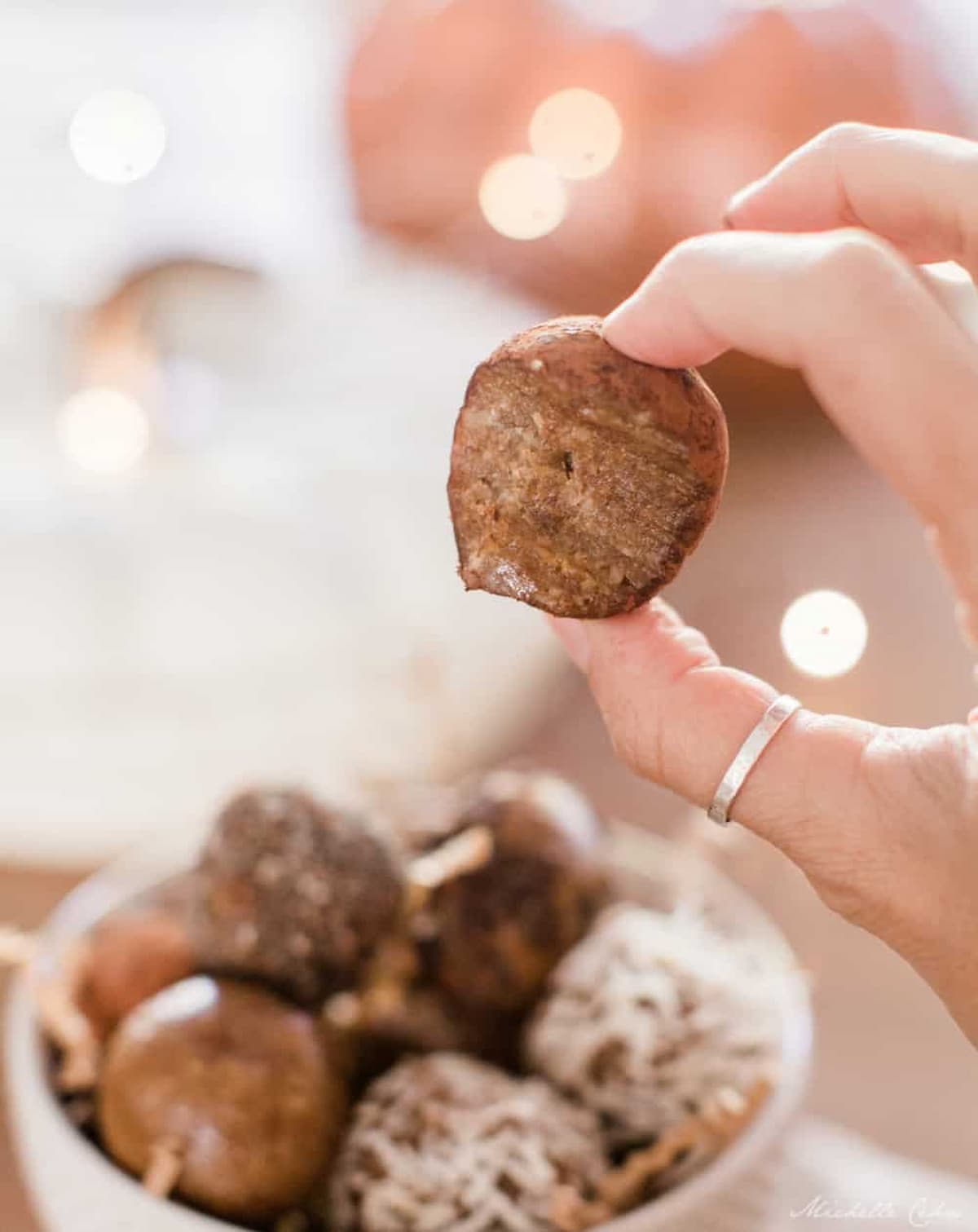 A hand holding a date truffle.