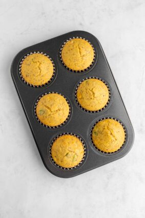 Cornbread muffins baked in a muffin tin. 