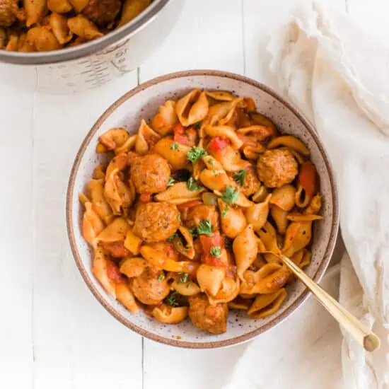 Vegan Instant Pot Pasta With Meatballs on a White Table with a Golden Spoon