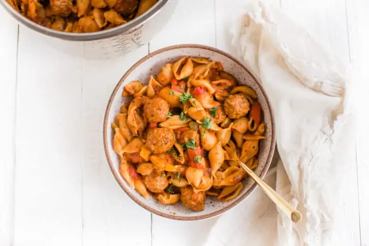 Vegan Instant Pot Pasta With Meatballs on a White Table with a Golden Spoon