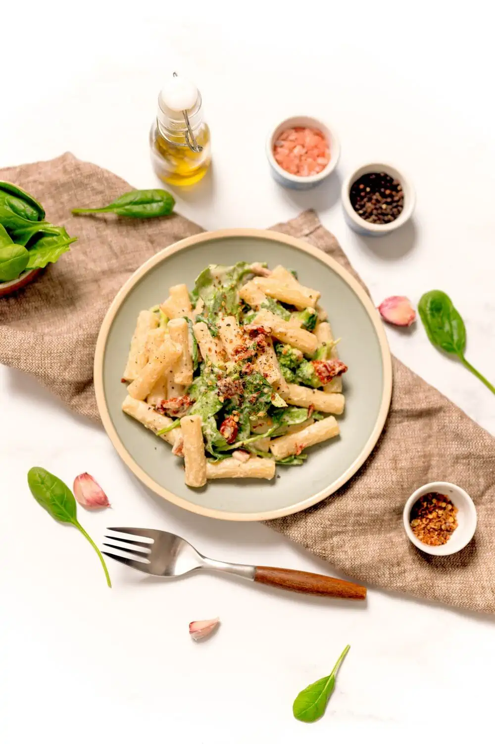 Dairy-Free Hummus Pasta Recipe With A Creamy Chickpea Cheeseless Sauce, Sun Dried Tomatoes, Broccoli, And Spinach