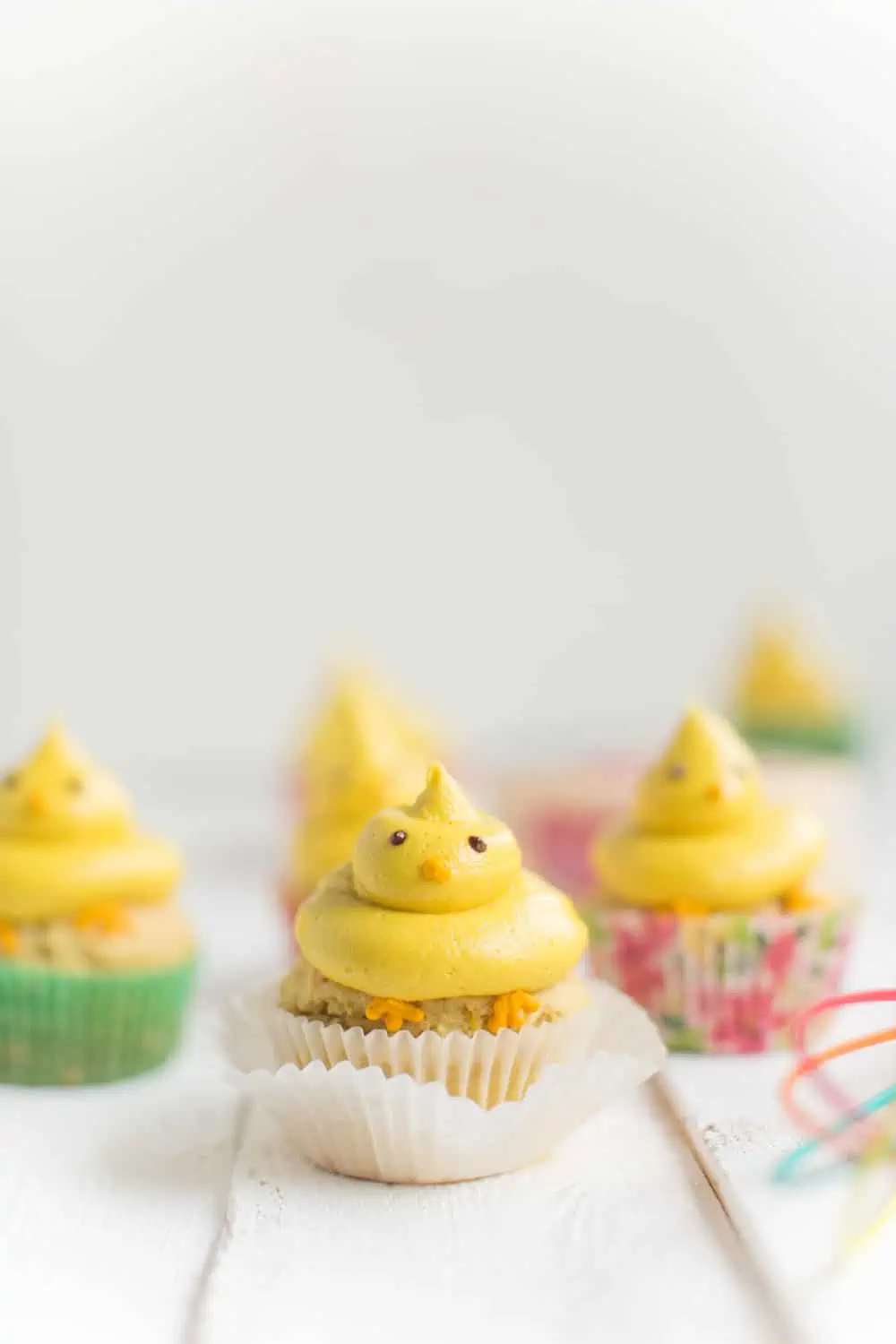 Vegan Easter cupcakes decorated to look like little yellow chicks.